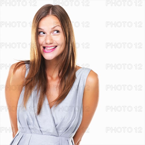 Studio portrait of woman biting tongue. Photo: momentimages