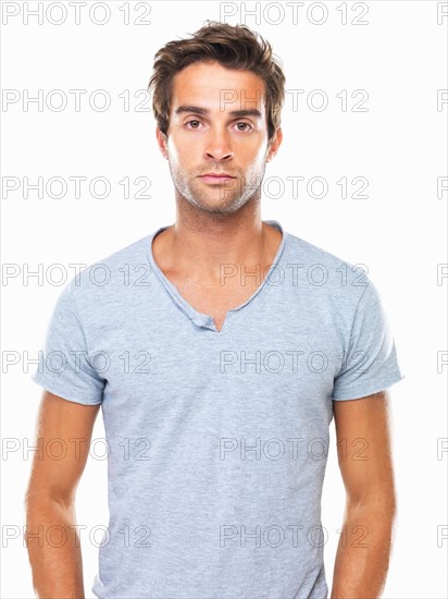 Studio portrait of angry young man flaring nostrils. Photo: momentimages