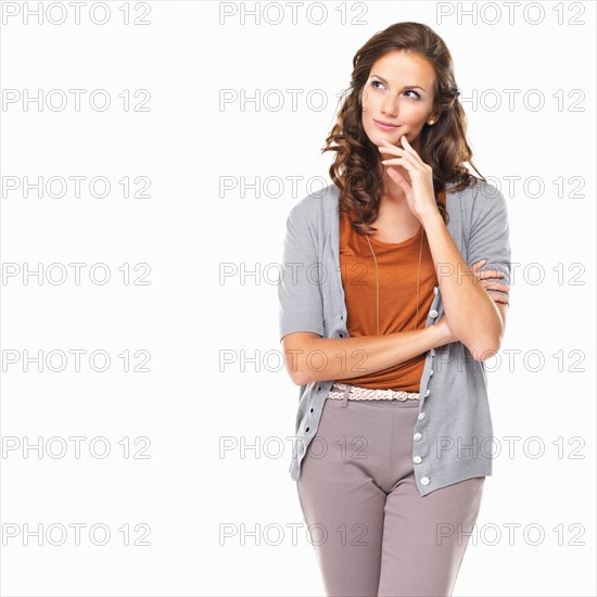 Studio portrait of beautiful young woman looking away and thinking. Photo : momentimages