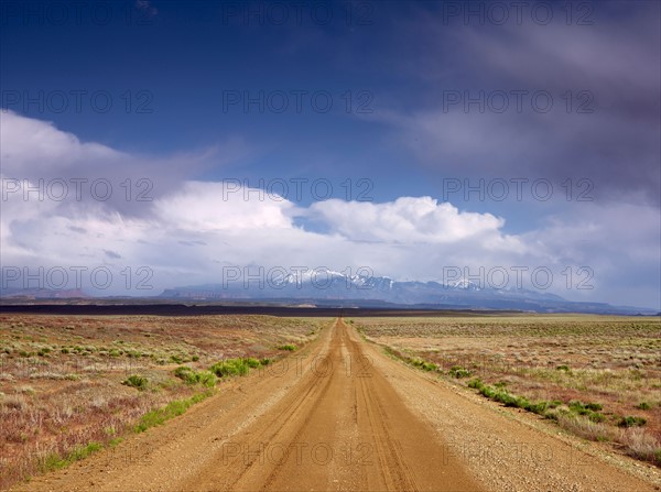 USA, Utah, Dirt road crossing landscape. Photo: John Kelly