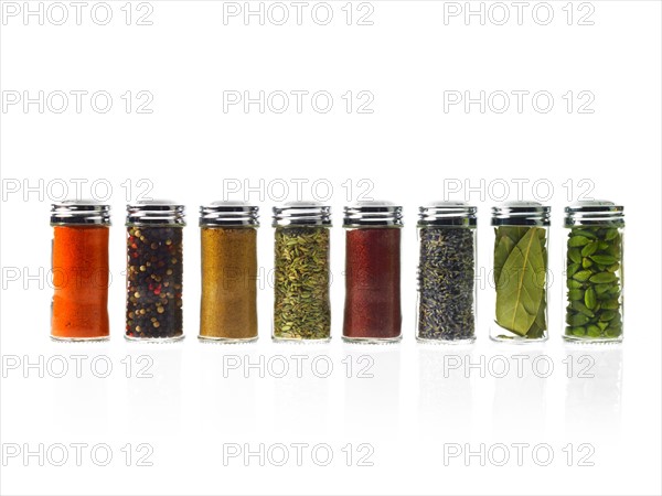 Studio shot of row of jars with spices. Photo : David Arky