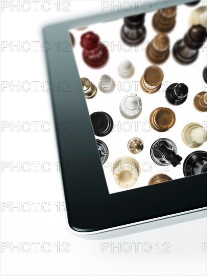 Studio shot of chess pieces on digital tablet. Photo : David Arky