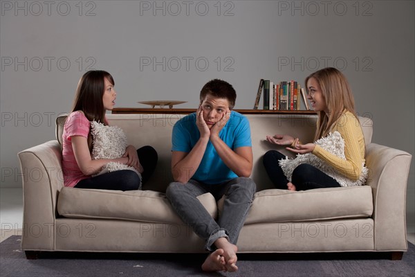 Portrait of teenage boy (16-17) and girl (16-17) with young friend. Photo : Rob Lewine