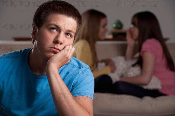 Portrait of teenage boy (16-17) and girl (16-17) with young friend. Photo : Rob Lewine