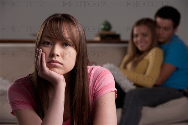 Portrait of teenage boy (16-17) and girl (16-17) with young friend. Photo: Rob Lewine