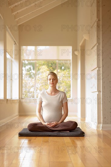 Pregnant woman practicing yoga. Photo : Rob Lewine