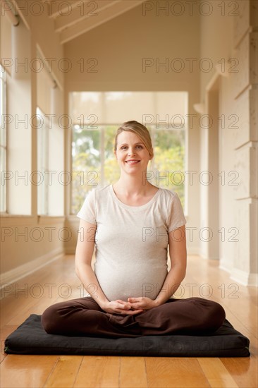 Pregnant woman practicing yoga. Photo : Rob Lewine