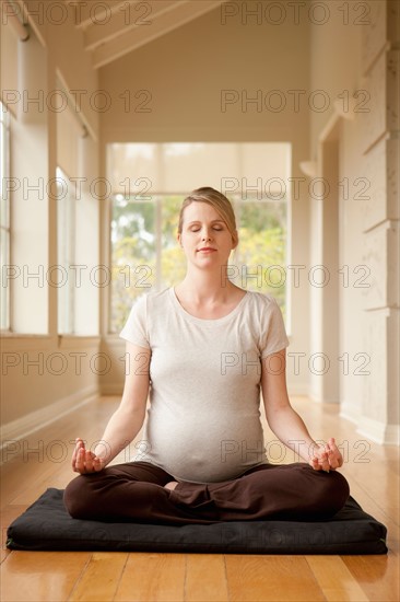 Pregnant woman practicing yoga. Photo : Rob Lewine