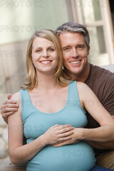 Portrait of pregnant woman with husband. Photo : Rob Lewine