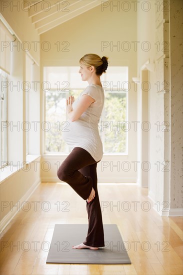 Pregnant woman practicing yoga. Photo : Rob Lewine