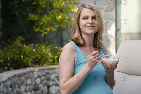 Pregnant woman eating dessert. Photo : Rob Lewine