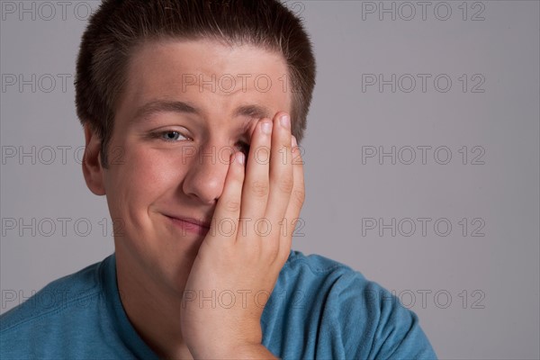 Portrait of sleepy teenager, studio shot. Photo : Rob Lewine