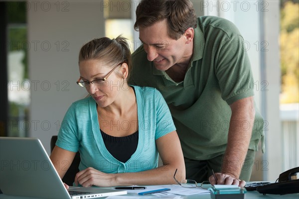 Mature couple working on laptop at home. Photo: Rob Lewine