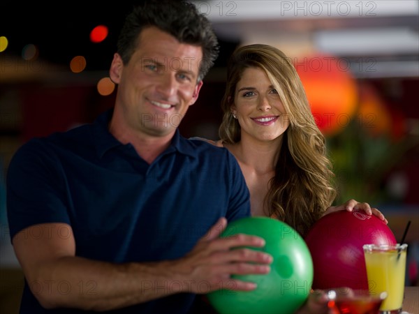 Man and woman with bowling balls. Photo: db2stock