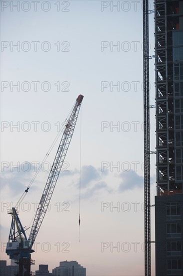 USA, New York State, New York City, Cranes against sky. Photo: fotog