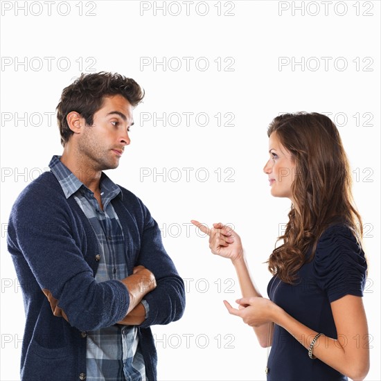 Studio shot of young couple having argument. Photo : momentimages