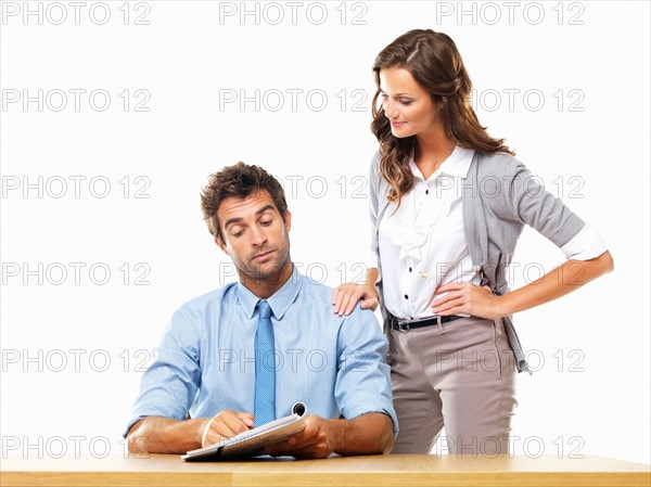 Business woman and business man reading document together. Photo: momentimages