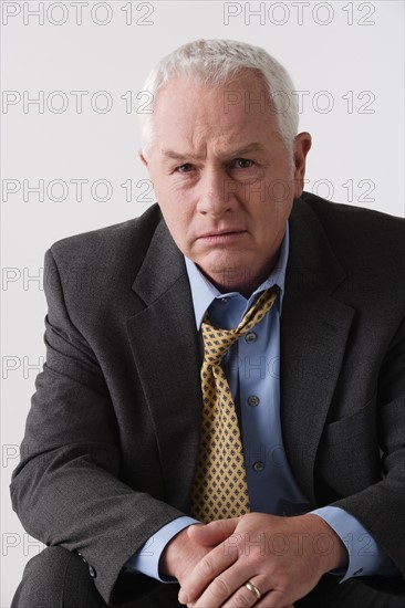 Portrait of senior businessman, studio shot. Photo : Rob Lewine