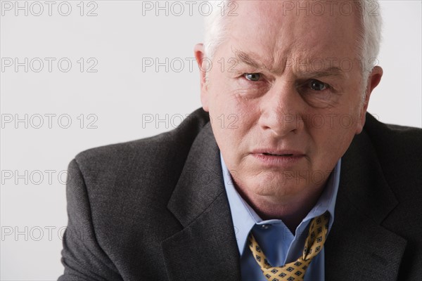 Portrait of senior businessman, studio shot. Photo : Rob Lewine