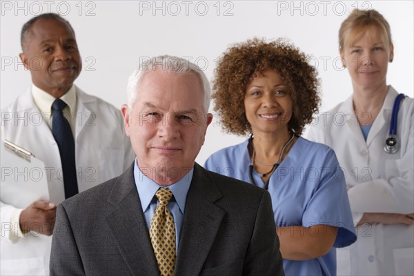 Portrait of four medical professionals, studio shot. Photo : Rob Lewine