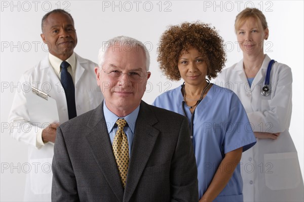 Portrait of four medical professionals, studio shot. Photo: Rob Lewine