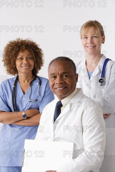 Portrait of three medical professionals, studio shot. Photo: Rob Lewine