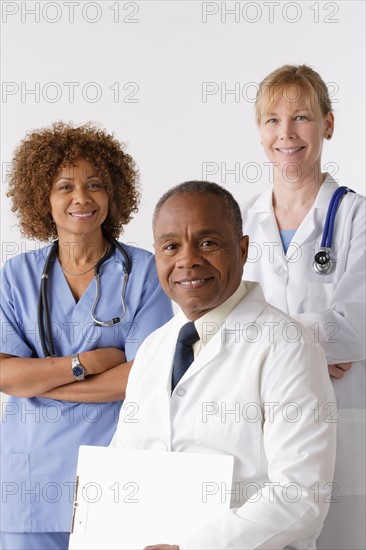 Portrait of three medical professionals, studio shot. Photo : Rob Lewine