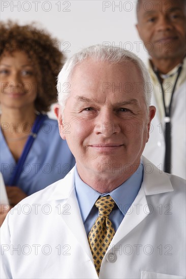 Portrait of three medical professionals, studio shot. Photo: Rob Lewine