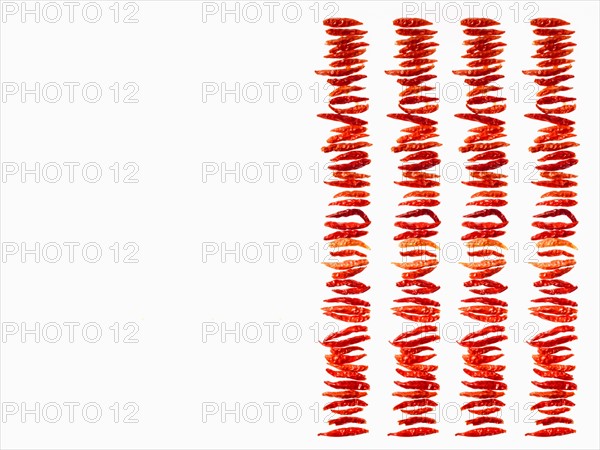 Studio shot of Red Chili Peppers on white background. Photo : David Arky