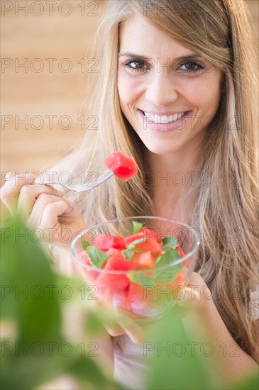 Woman eating watermelon. Photo : Jamie Grill