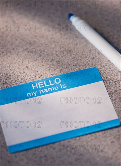 Close up of blank name tag and pen. Photo: Daniel Grill