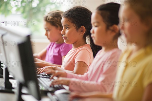 Four girls (6-9) using computers.