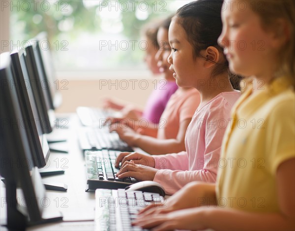 Four girls (6-9) using computers.