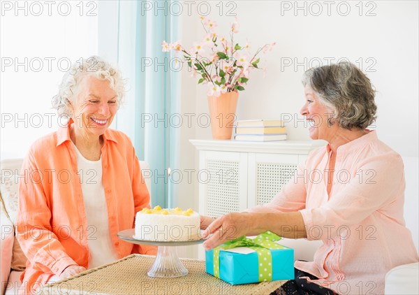 Two senior women celebrating birthday. Photo : Daniel Grill