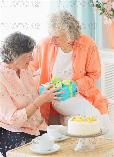 Two senior women celebrating birthday. Photo: Daniel Grill