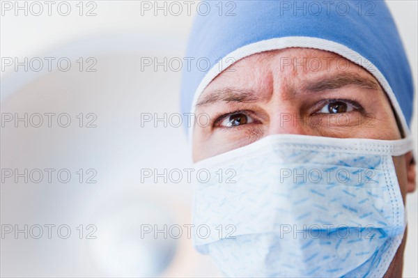 Male surgeon wearing surgical mask.