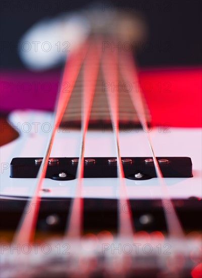 Close up of strings of bass guitar. Photo : Daniel Grill