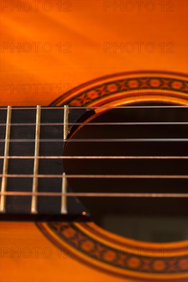 Close up of sound hole of acoustic guitar. Photo : Daniel Grill