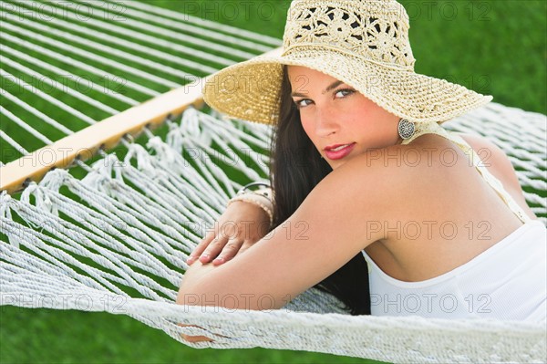 Woman relaxing in hammock.