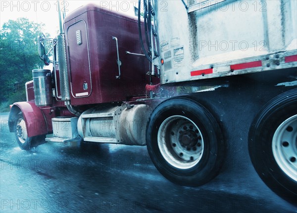 Old truck driving in rain.