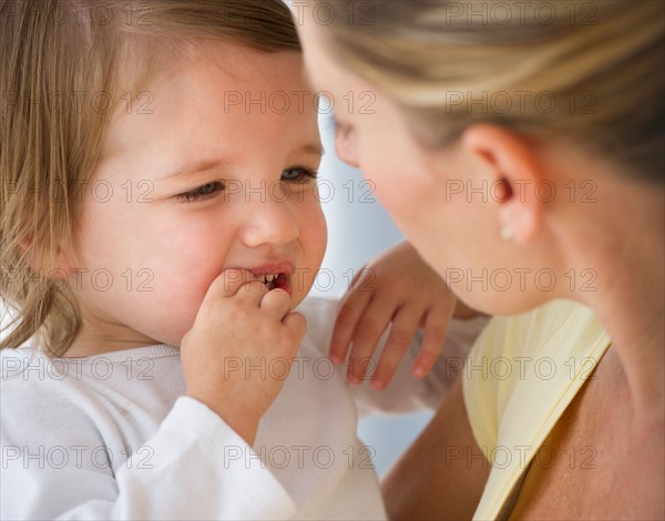 Mother holding daughter (2-3).