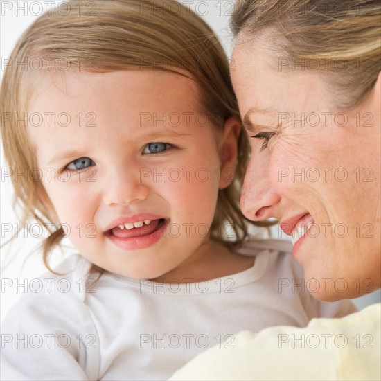 Mother holding daughter (2-3).