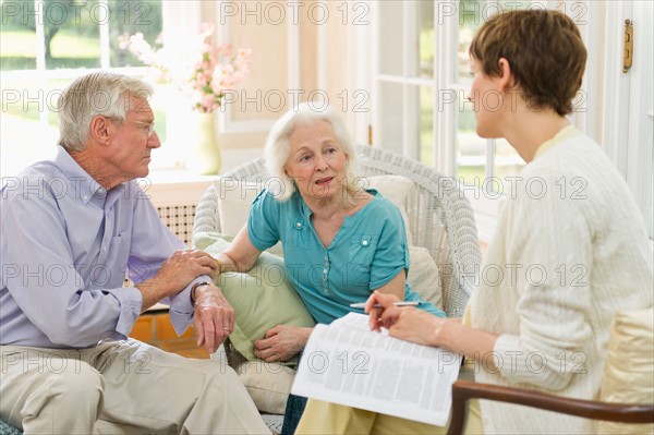 Nursing assistant talking with seniors in Nursing home.