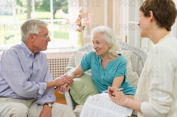 Nursing assistant talking with seniors in Nursing home.