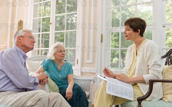 Nursing assistant talking with seniors in Nursing home.