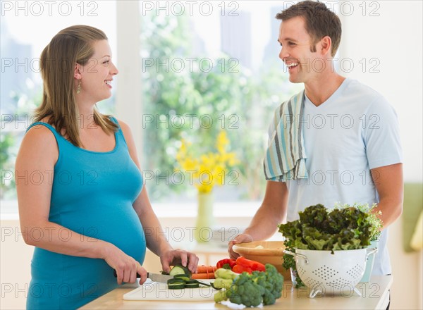 Young couple preparing food.