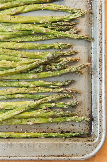 Close up of roasted asparagus on baking sheet. Photo : Jamie Grill