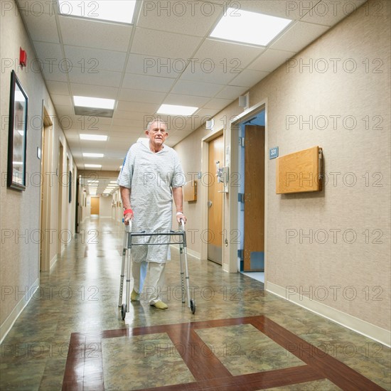 Senior man in hospital walking with walker. Photo: Erik Isakson