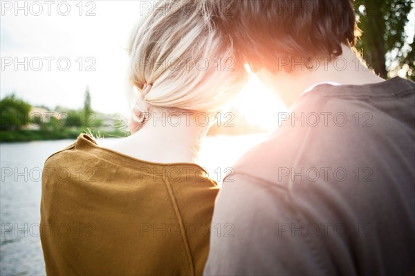 Rear view of young couple looking at sunset. Photo: Take A Pix Media