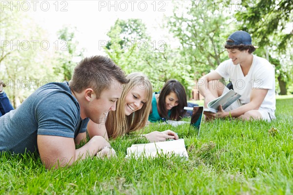 College students relaxing on grass. Photo: Take A Pix Media